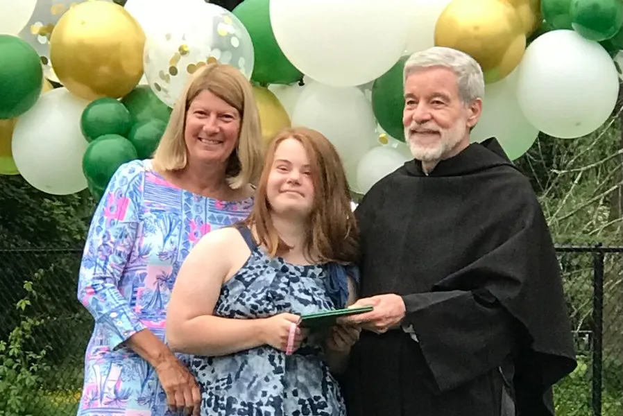 Pastor of St. Augustine's, Fr. Peter Gori O.S.A. (right) and admissions director Paula O'Dea (left) hand Abby Aguedelo her diploma on graduation day.?w=200&h=150